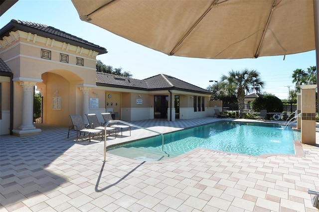 view of swimming pool with a patio