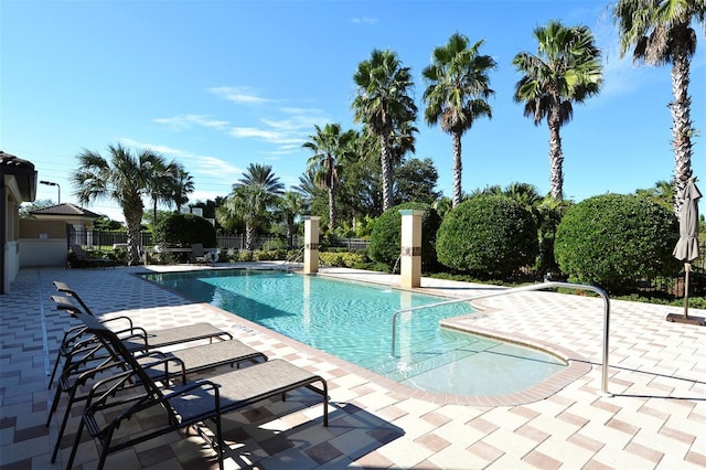 pool featuring a patio and fence