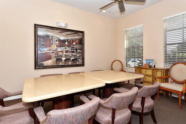 dining room with a ceiling fan and carpet floors