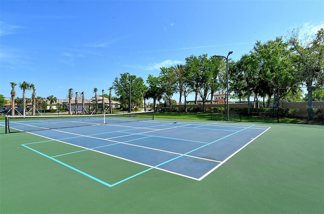 view of tennis court with fence