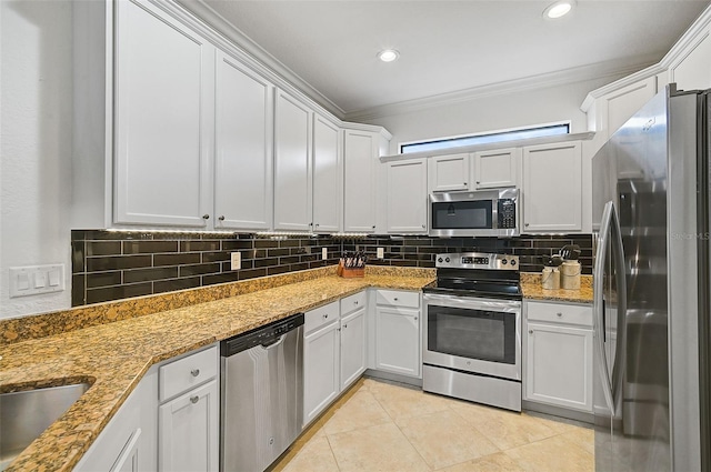 kitchen featuring tasteful backsplash, crown molding, light stone counters, light tile patterned flooring, and stainless steel appliances