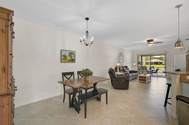 dining room with light tile patterned floors, ceiling fan with notable chandelier, crown molding, and baseboards