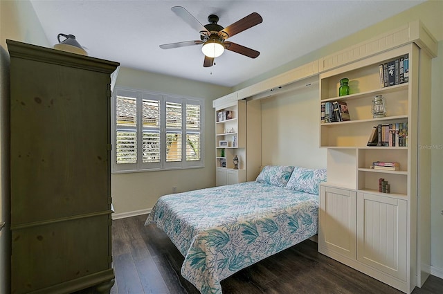 bedroom featuring dark wood finished floors, ceiling fan, and baseboards