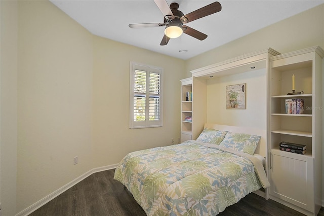 bedroom with dark wood finished floors, a ceiling fan, and baseboards