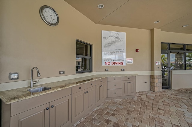 kitchen with light stone counters and sink