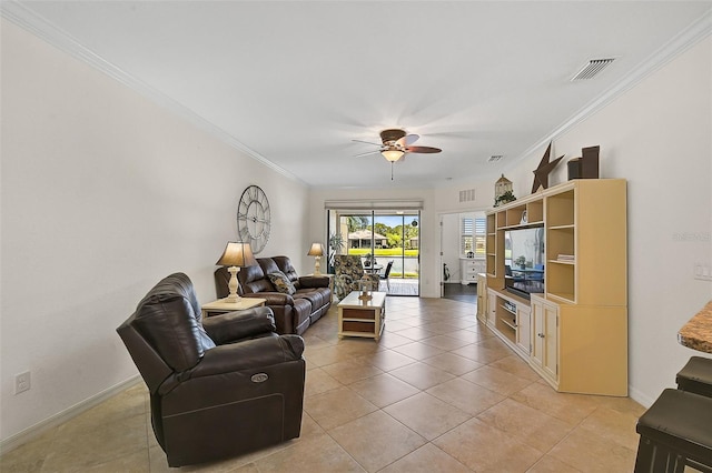 tiled living room featuring ceiling fan and ornamental molding