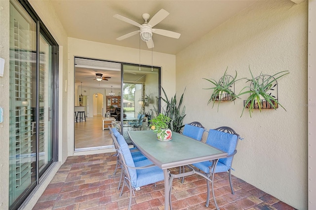 sunroom featuring ceiling fan