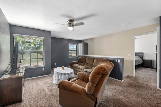 carpeted living room featuring a textured ceiling and ceiling fan