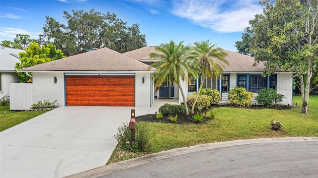 view of front of property featuring a front yard and a garage