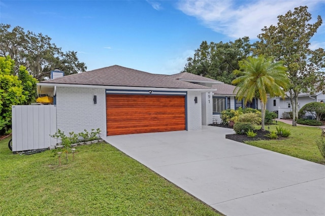 view of front facade with a garage and a front yard