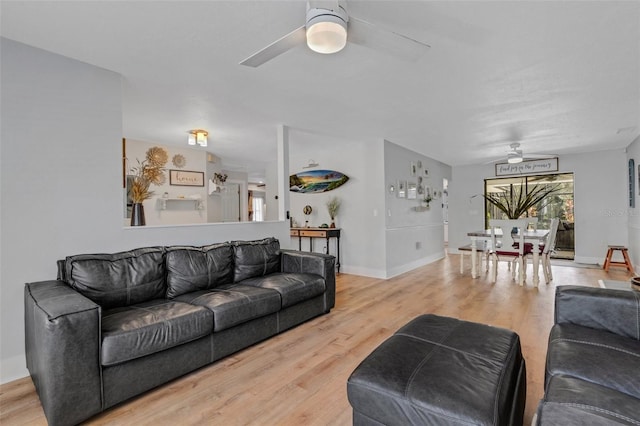 living room with ceiling fan and light hardwood / wood-style floors