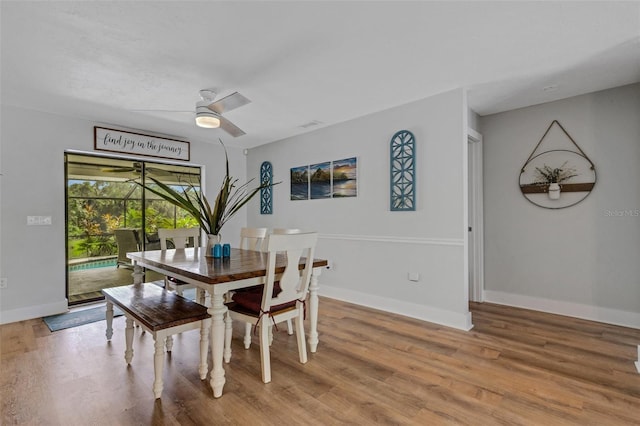 dining area featuring ceiling fan and wood-type flooring