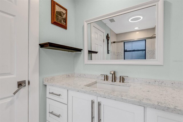 bathroom with vanity and walk in shower