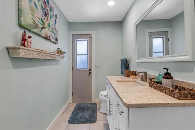 bathroom featuring tile patterned flooring, vanity, and toilet