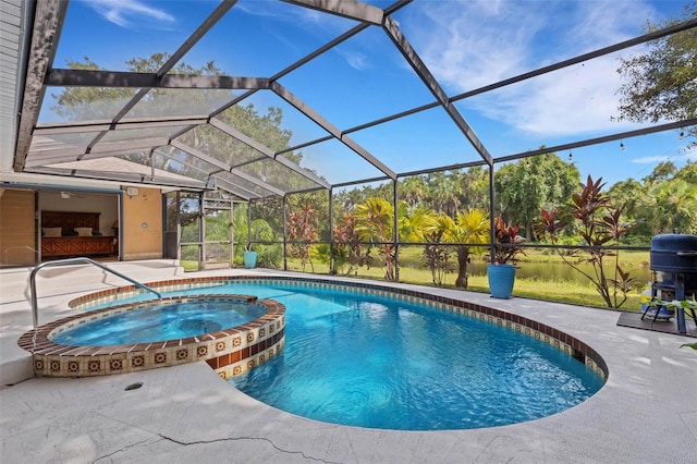 view of pool featuring glass enclosure, an in ground hot tub, and a patio