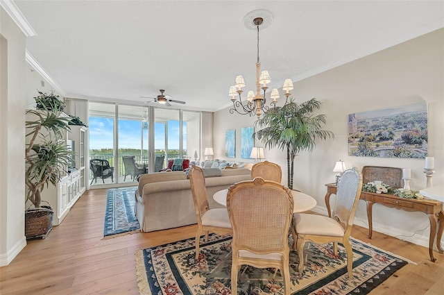 dining room featuring light wood-type flooring, ceiling fan with notable chandelier, and ornamental molding