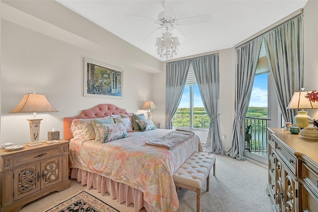 carpeted bedroom with ceiling fan and access to exterior