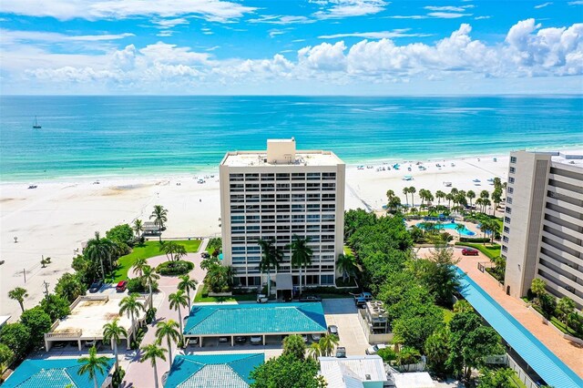 aerial view with a water view and a beach view