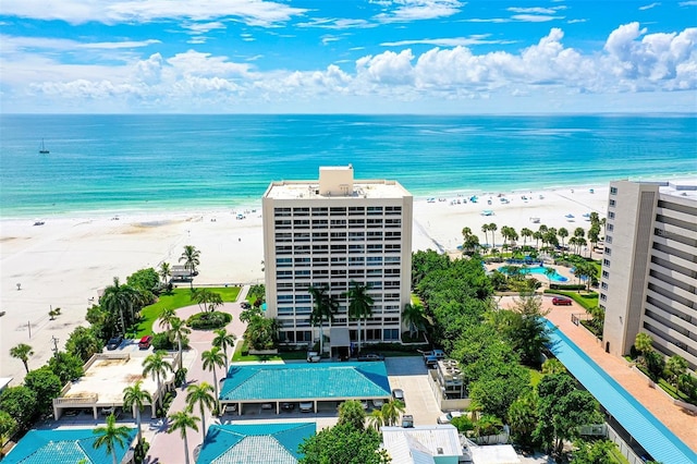 drone / aerial view featuring a water view and a view of the beach