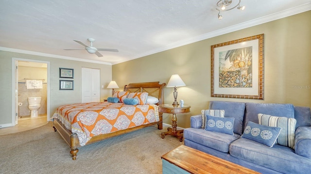 bedroom with carpet floors, ensuite bath, and ornamental molding