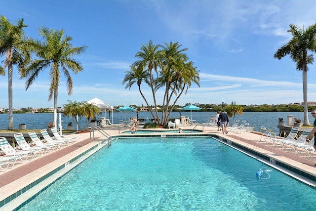 community pool featuring a patio area and a water view