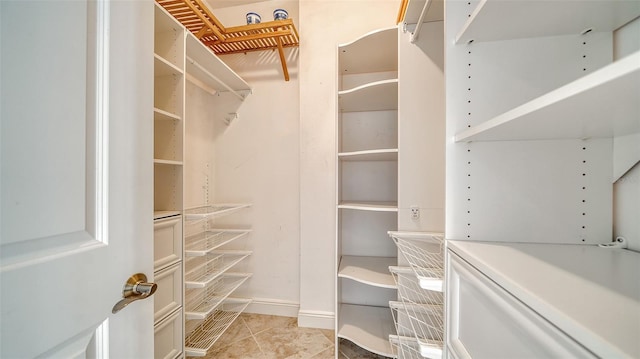 walk in closet featuring light tile patterned floors