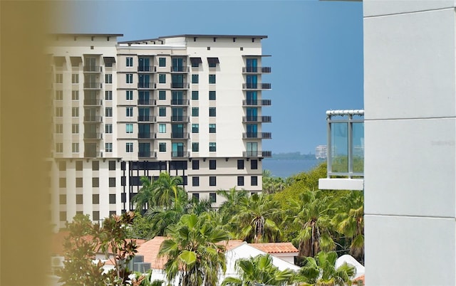 view of building exterior with cooling unit and a water view