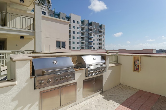 view of patio with grilling area, a balcony, and area for grilling