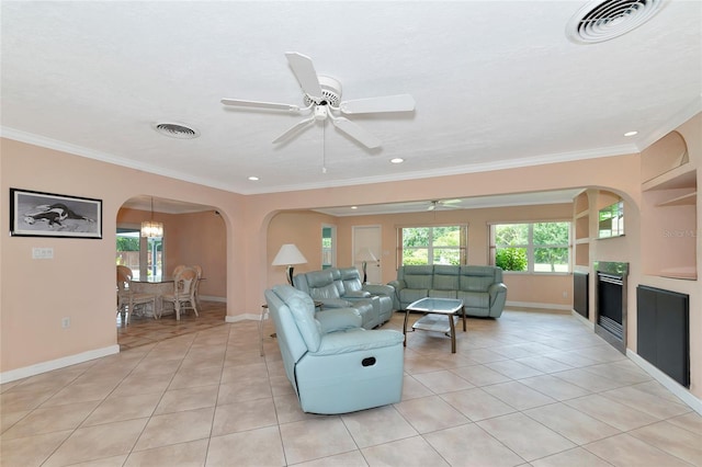 living area featuring light tile patterned flooring, visible vents, and a healthy amount of sunlight