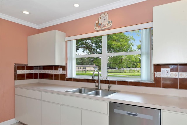 kitchen featuring white cabinets, dishwasher, light countertops, crown molding, and a sink