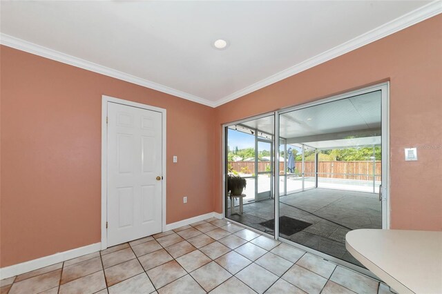 interior space with crown molding, baseboards, and light tile patterned floors