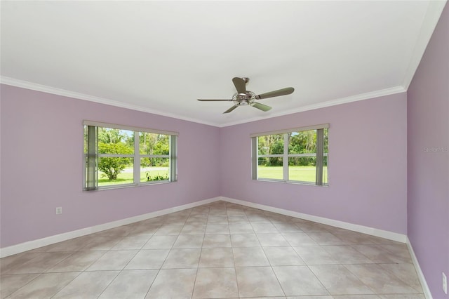 spare room with ceiling fan, ornamental molding, light tile patterned floors, and baseboards