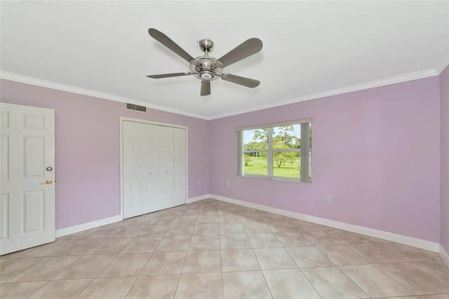 unfurnished bedroom featuring a ceiling fan, visible vents, baseboards, ornamental molding, and a closet