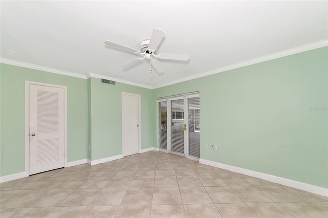 unfurnished room with light tile patterned floors, visible vents, baseboards, a ceiling fan, and ornamental molding