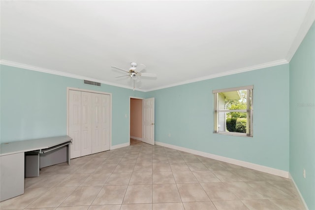 unfurnished bedroom with visible vents, a closet, baseboards, and crown molding