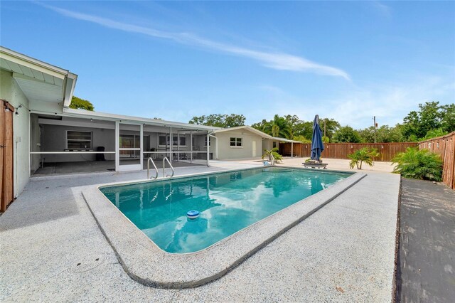 view of pool featuring a sunroom, a patio, a fenced backyard, and a fenced in pool