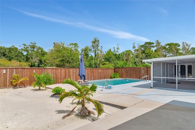 view of pool with a sunroom, a fenced backyard, a patio area, and a fenced in pool