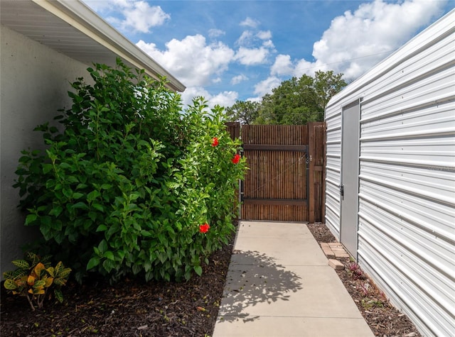 view of patio with fence and a gate