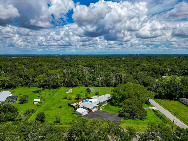 birds eye view of property with a view of trees