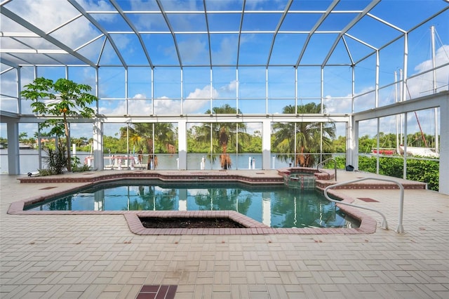 view of pool with a patio area, glass enclosure, and a pool with connected hot tub