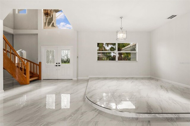 entrance foyer featuring an inviting chandelier