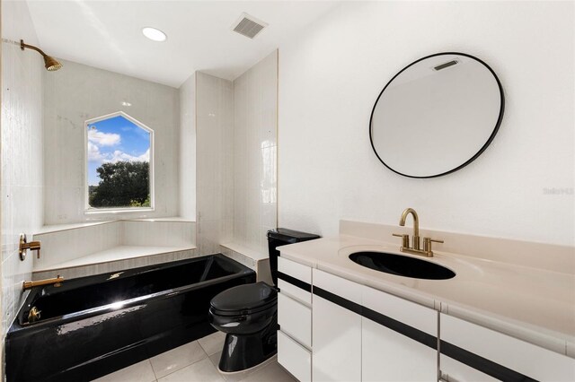 full bathroom featuring vanity, toilet, tile patterned floors, and tiled shower / bath