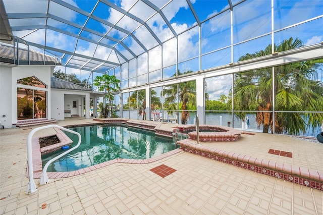 view of pool featuring glass enclosure, a patio, an in ground hot tub, and a water view