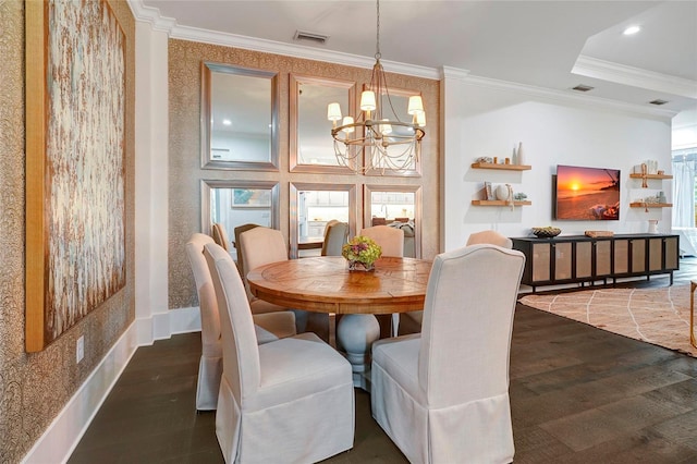 dining area featuring ornamental molding, dark wood-type flooring, and an inviting chandelier