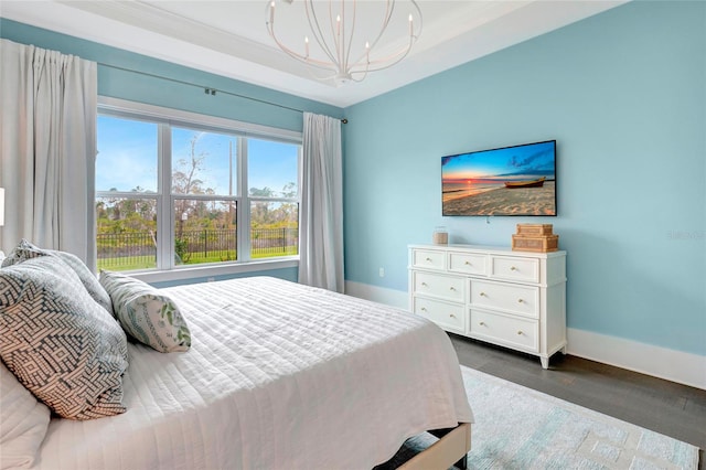 bedroom featuring a notable chandelier and dark hardwood / wood-style floors