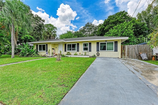 single story home featuring a front lawn and fence