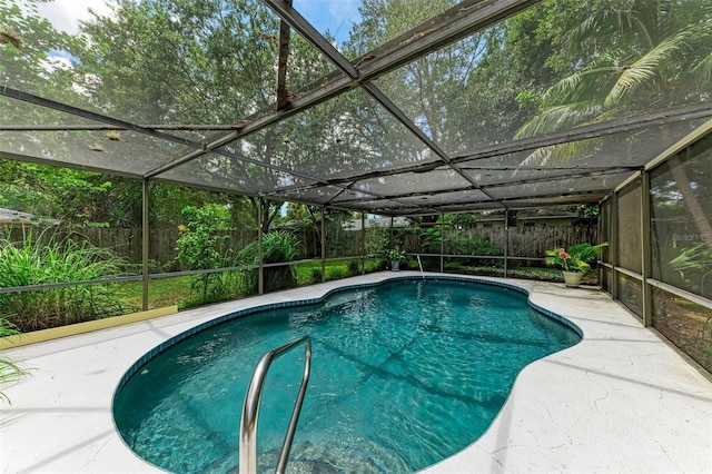 view of swimming pool with a patio area, a fenced backyard, a fenced in pool, and a lanai