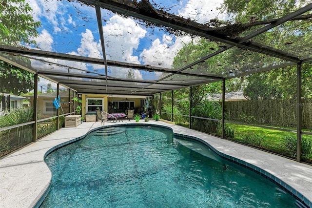 view of pool with a fenced in pool, glass enclosure, and a patio area