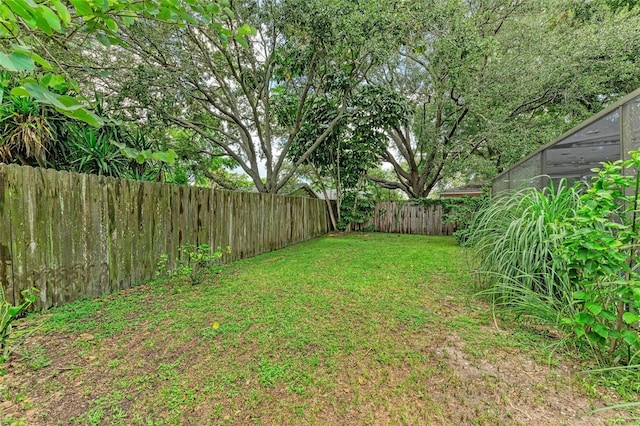 view of yard with a fenced backyard