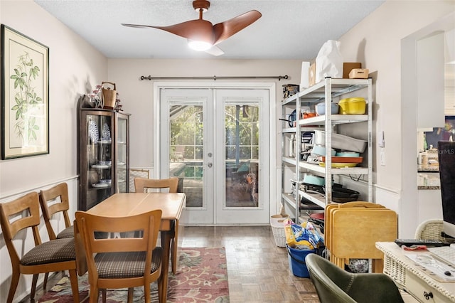 dining room featuring french doors, a textured ceiling, parquet floors, and ceiling fan